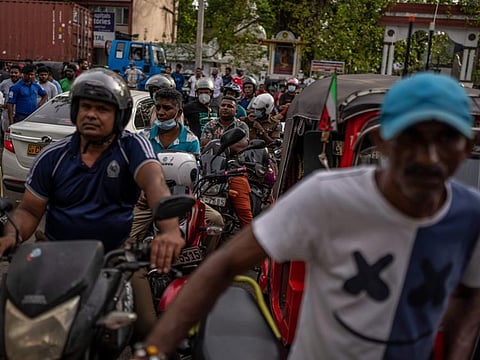 Sri Lankan wait in queue to buy petrol at a fuel station, in Colombo, Sri Lanka, Sunday, July 17, 2022.