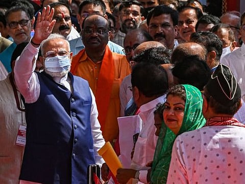 Indian Prime Minister Narendra Modi (L) gestures after casting his vote to elect the next Indian president at Parliament House in New Delhi on July 18, 2022.
