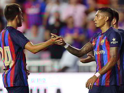 Raphinha (right) celebrates with Eric Garcia of FC Barcelona after scoring against Inter Miami CF at DRV PNK Stadium in Fort Lauderdale, Florida.