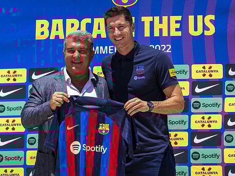 Robert Lewandowski and Joan Laporta hold up an FC Barcelona jersey during the press conference introducing him to FC Barcelona at Conrad Fort Lauderdale Beach on Wednesday.