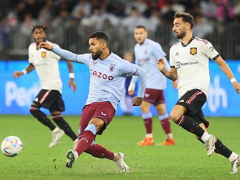 Douglas Luiz (left) of Aston Villa is chased by Manchester United player Bruno Fernandes during a friendly match at Optus Stadium in Perth.