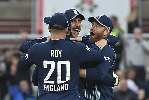 England's cricketers celebrate the dismissal of South Africa's Aiden Markram during the second one-day international cricket match between England and South Africa in Manchester, England.
