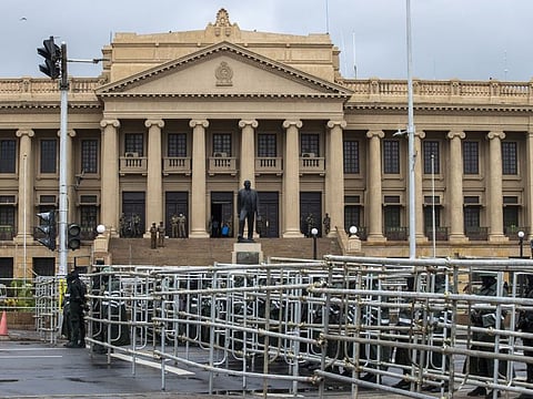 Military members stand guard at the newly-built street barricades after the protester site has been dismantled outside the president's office in Colombo, Sri Lanka.