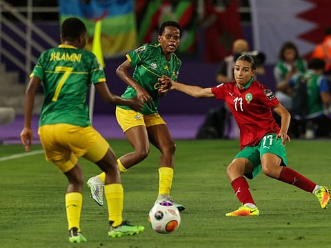 Morocco's forward Hanane Ait el-Haj (right) marks South Africa's midfielder Hildah Magaia (centre) during the 2022 Women's Africa Cup of Nations final football match at the Prince Moulay Abdellah Stadium in Rabat.