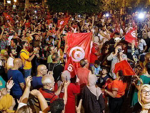 Supporters of president Kais Saied celebrate after exit poll indicates voters backed new constitution in Tunis, Tunisia July 25, 2022.
