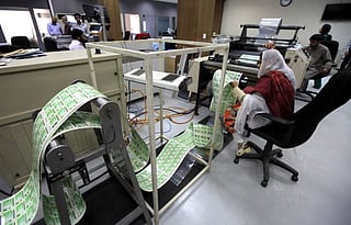 A worker of the National Database and Registration Authority (NADRA) checks newly printed government identity cards of registered citizens at the NADRA head office in Islamabad. File photo for illustrative purpose only