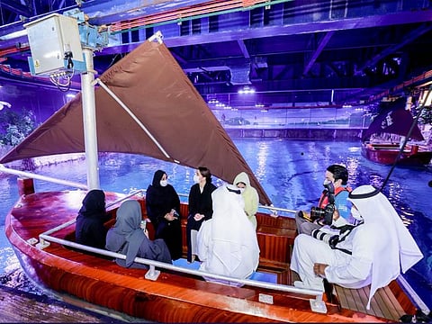 Mariam bint Mohammed Almheiri, Minister of Climate Change and the Environment, and other officials being given a tour of the National Aquarium on a glass-bottomed Bu Tinah boat, allowing them to enjoy a unique view of the marine species.