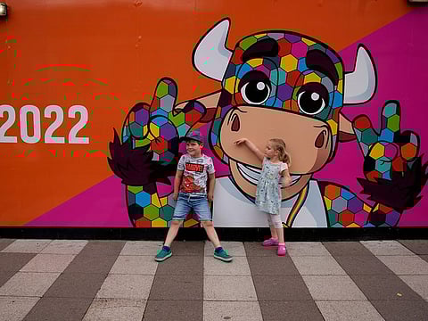 Let the Games begin: Two children stand in front of a banner displaying Perry, the official mascot of the Birmingham 2022 Commonwealth Games in Birmingham, England. The Commonwealth Games will be inaugurated later on Thursday.