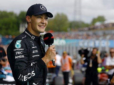 Mercedes' George Russell gives a speech after qualifying in pole position.