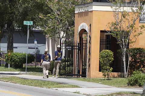 Law enforcement officials investigate the Uhuru House, a Black international socialist organisation, on Friday, July 29, 2022, in St. Petersburg, Fla. AP