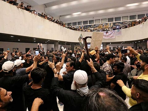 Protestors gather inside Iraq's parliament in the capital Baghdad's high-security Green Zone, on July 31, 2022, a day after storming it 