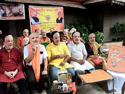 Bharatiya Janata Party (BJP) supporters listen to Prime Minister Narendra Modi's 'Mann Ki Baat' on AIR radio, in Kolkata on Sunday. 