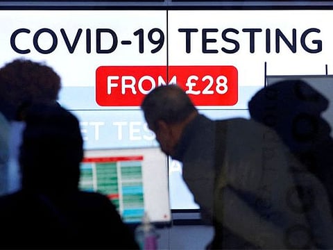 File phto. Customers are seen inside a private COVID-19 testing clinic in a busy shopping area in London, Britain. 