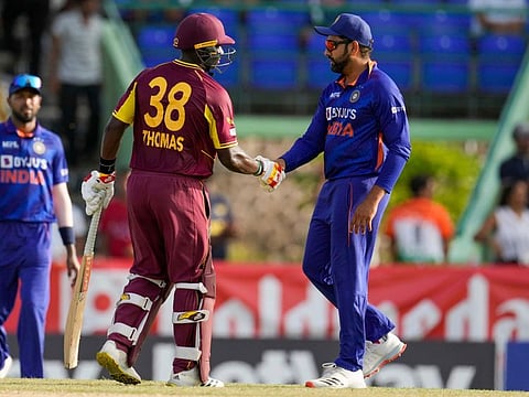West Indies' Devon Thomas (left) with India's captain Rohit Sharma at the end of their second T20 cricket match at Warner Park in Basseterre, St. Kitts and Nevis. West Indies won by 5 wickets.