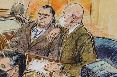 An artist sketch depicts Guy Wesley Reffitt, joined by his lawyer William Welch, right, in Federal Court, in Washington, on February 28, 2022.