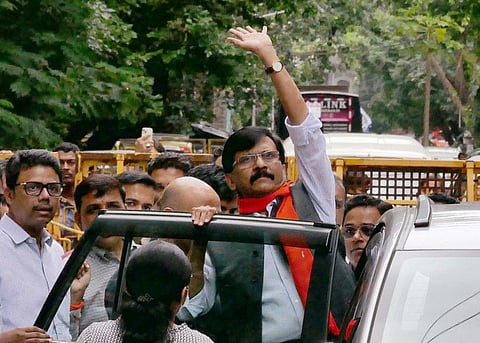 Shiv Sena MP Sanjay Raut waves to his supporters while being produced in a special court in alleged connection with the Patra Chawl scam, in Mumbai on Thursday, August  4, 2022.