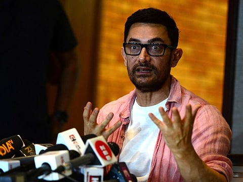 In this file photo taken on March 14, 2022, Bollywood actor Aamir Khan talks to media during an event held to celebrate his 57th birthday in Mumbai. 