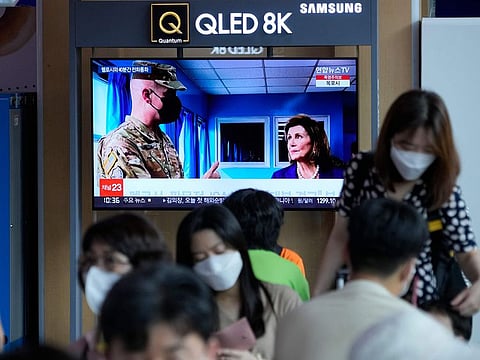 A TV screen shows a news program reporting about US House Speaker Nancy Pelosi was visiting the Joint Security Area of the inter-Korean truce village of Panmunjom, at the Seoul Railway Station in Seoul, South Korea, on August 5, 2022. 
