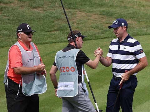 Round two leader Julien Guerrier (right) congratulated by his caddie on completion of his round.
