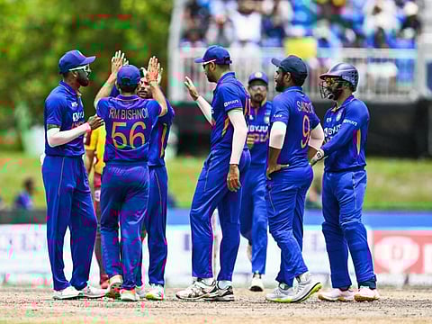 India's Kuldeep Yadav celebrates the dismissal of West Indies Nicholas Pooran with teammates during the 5th and final T20I match at the Central Broward Regional Park in Lauderhill.