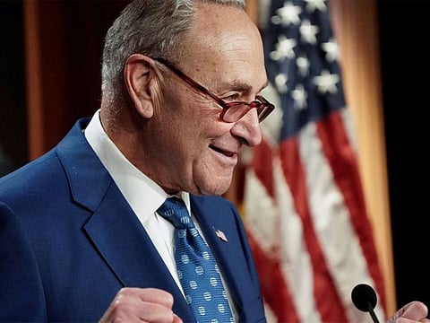  US Senate Majority Leader Chuck Schumer (D-NY) speaks to the media after the 51-50 vote passed the "Inflation Reduction Act of 2022" on Capitol Hill in Washington. 