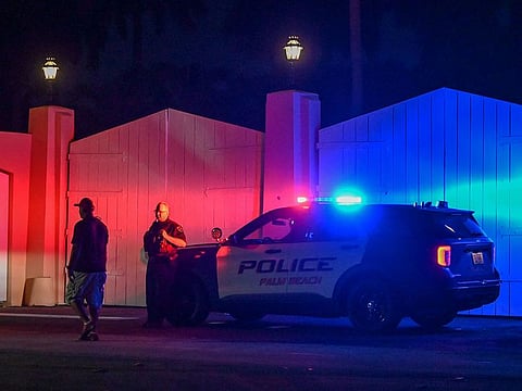 A police car is seen outside former US President Donald Trump's residence in Mar-A-Lago, Florida on August 8, 2022.