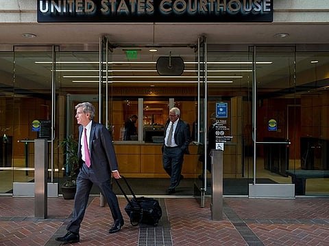 Robert Walters, front, attorney representing three LIV Golf players, leaves a federal courthouse in San Jose, Calif., Tuesday, Aug. 9, 2022.