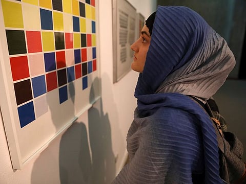 A visitor looks at artworks by the American artist Sol Lewitt while visiting a 19th and 20th-century American and European minimalist and conceptual masterpieces show at the Tehran Museum of Contemporary Art in Tehran.