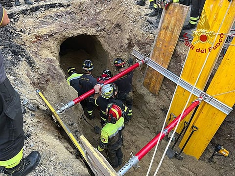 First responders during a rescuing operation for a suspected thief who was buried under rubble for about eight hours.