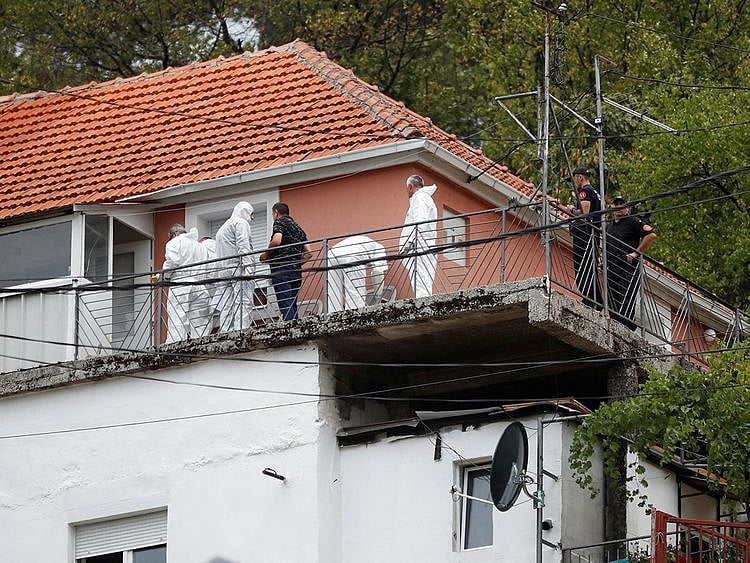 Police forensic team inspect the house where a gunman started a mass shooting in which 12 people, including the gunman, were killed, according to local media reports, in Cetinje, Montenegro on August 12, 2022.