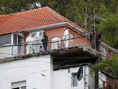 Police forensic team inspect the house where a gunman started a mass shooting in which 12 people, including the gunman, were killed, according to local media reports, in Cetinje, Montenegro on August 12, 2022. 