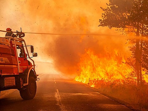 Firefighters tackle a blaze near Saint-Magne, south of Bordeaux, southwestern France.
