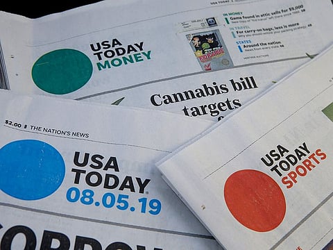 Sections of a USA Today newspaper lie on display, in Norwood, Massachusetts. 