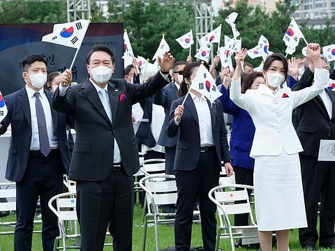 South Korean President Yoon Suk Yeol, second from left, and his wife Kim Keon Hee give three cheers for his country during a ceremony to celebrate Korean Liberation Day from Japanese colonial rule in 1945, at the presidential office square in Seoul on August 15, 2022.