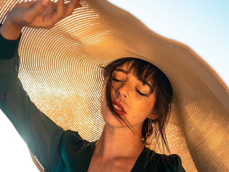 Woman under straw hat pexels.com