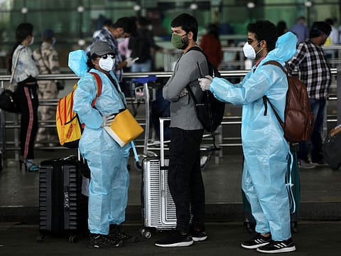 Passengers stand in a queue to enter Chhatrapati Shivaji International Airport in Mumbai in a file photo.