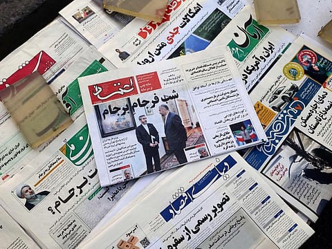 A picture shows a newspaper stall with a view of Etemad newspaper's front page bearing a title reading in Farsi "The night of the end of the JCPOA ", and cover photos of Iran's Foreign Minister Hossein Amir Abdollahian his deputy and chief nuclear negotiator Ali Bagheri Kani, in the capital Tehran on August 16, 2022.  