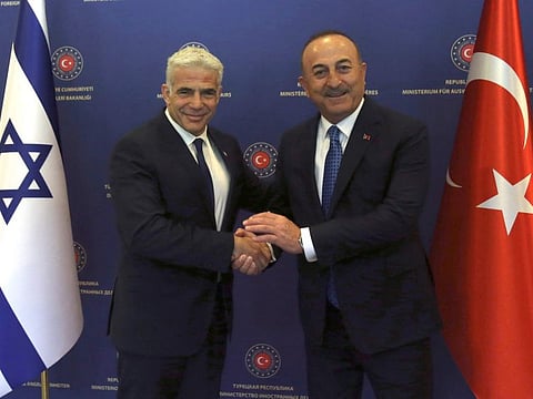 Turkish Foreign Minister Mevlut Cavusoglu, right, and Israeli Foreign Minister Yair Lapid pose for photos before their talks, in Ankara, Turkey, June 23, 2022.  