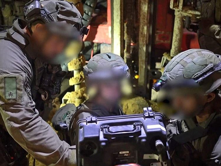 This image grab from a video released by the Israeli army on August 15, 2022, reportedly shows soldiers working at the site where the army said it had discovered and blocked a tunnel leading out of the Gaza Strip into Israel, dug by the Palestinian enclave's Hamas rulers. Israel raided the offices of several Palestinian advocacy groups it had previously designated as terrorist organisations, sealing entrance doors.