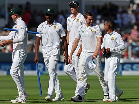 South Africa's players leave the pitch after wrapping up the game on day 3 of the first Test match against England at the Lord's cricket ground in London.
