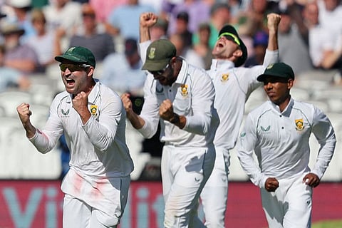 South Africa's Dean Elgar (left) and teammates celebrate after England's James Anderson is bowled by Marco Jansen to wrap up the first Test.