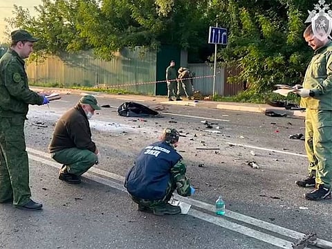  Investigators work on the site of explosion of a car driven by Daria Dugina outside Moscow.