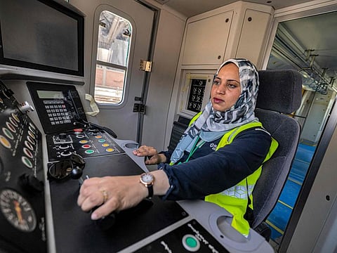 Hind Omar pilots a life-size train simulator at Adly Mansour station in the capital Cairo's northeastern neighbourhood of Heliopolis on May 31, 2022.  