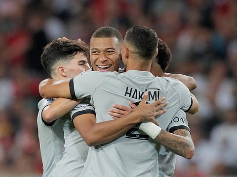 PSG's Kylian Mbappe (centre) is mobbed by teammate Achraf Hakimi after scoring against Lille at the Pierre Mauroy stadium in Villeneuve d'Ascq, northern France.