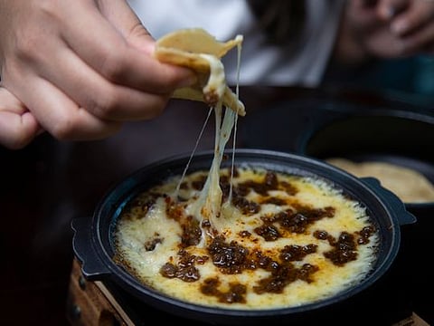Watch how to make Queso Fundido or three-cheese melt with spicy chorizo sausage