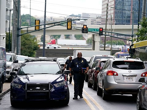 A police officer arrives on scene where a shooting occurred, Monday, Aug. 22, 2022, at a condominium in Atlanta. 