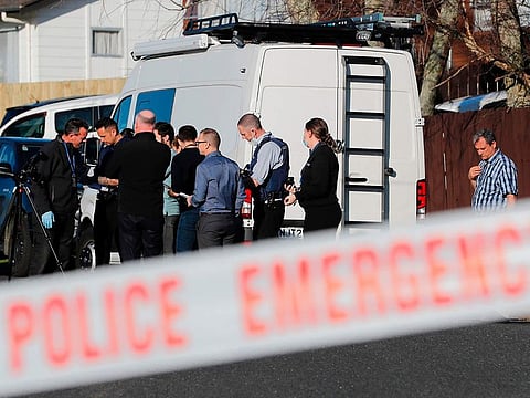 New Zealand police investigators work at a scene in Auckland on Aug. 11, 2022, after bodies were discovered in suitcases. 