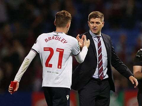Bolton Wanderers' Conor Bradley shakes hands with Aston Villa manager Steven Gerrard after the match.