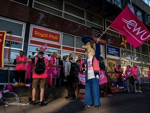 A striking postal worker from Royal Mail Plc, dressed as the cartoon character Postman Pat, demonstrates on a picket line outside the Whitechapel delivery office in London, UK, on Friday, Aug. 26. 2022.