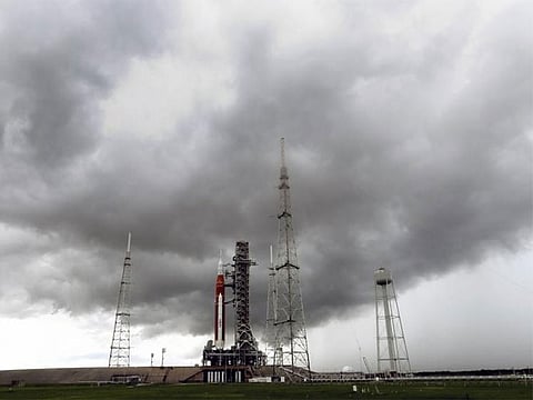  Storm clouds roll in over the NASA moon rocket as it stands ready for launch on Pad 39B for the Artemis 1 mission at the Kennedy Space Center, Saturday, Aug. 27, 2022, in Cape Canaveral.